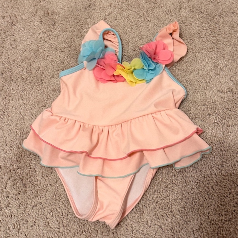 Pink Ruffled Swimsuit with Floral Accents